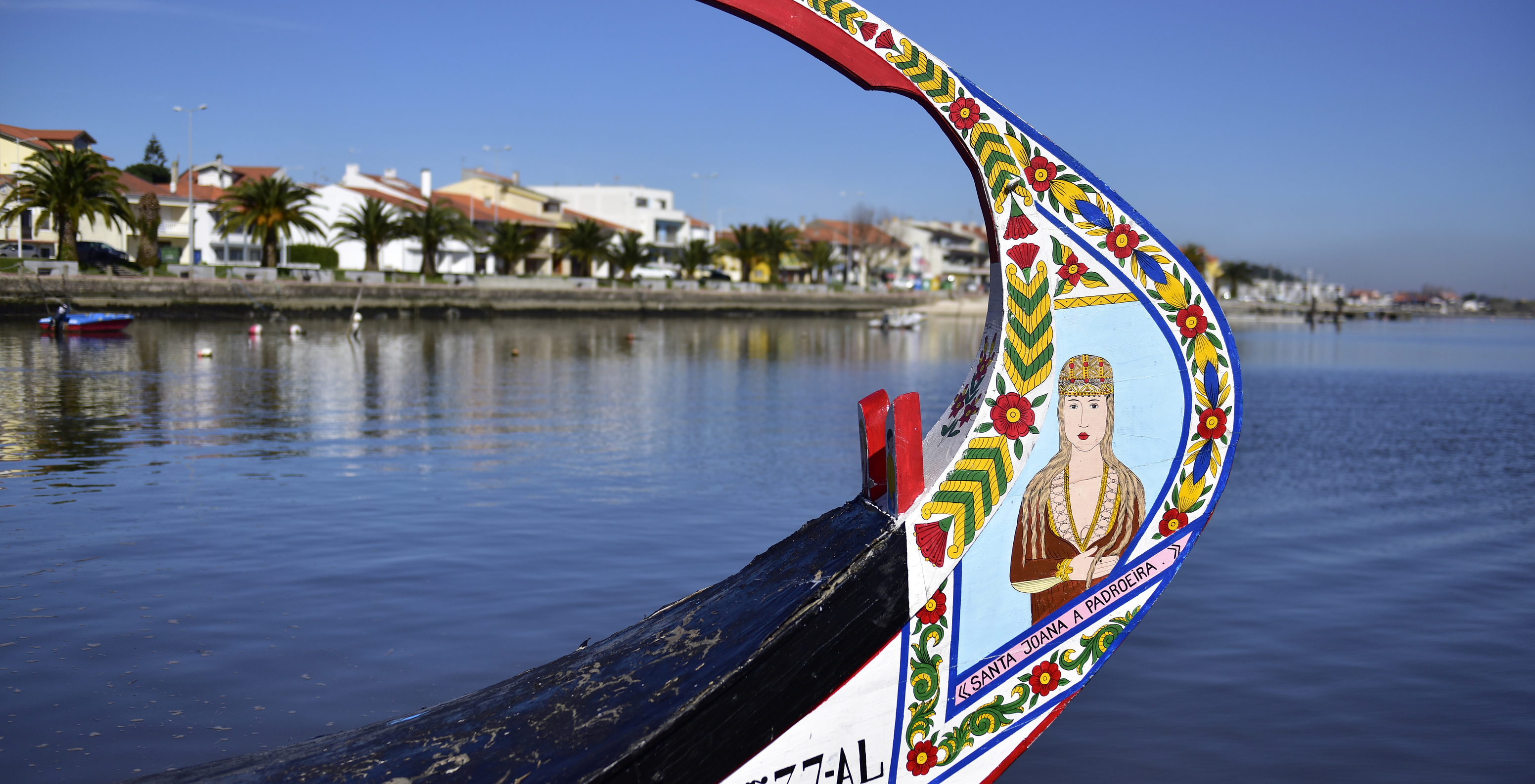 Moliceiro-Boot in Aveiro mit der Ria und der Stadt im Hintergrund