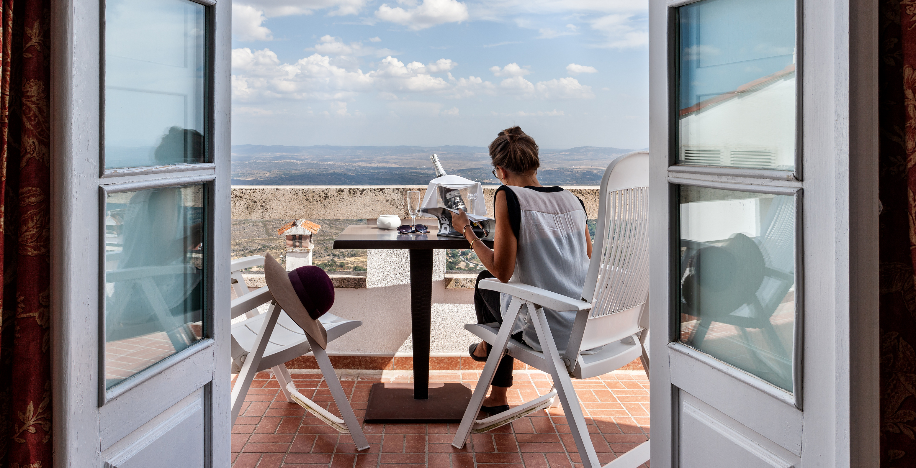 The Superior Suite with Balcony of The Pousada Marvão features a balcony with a view of the landscape and a table