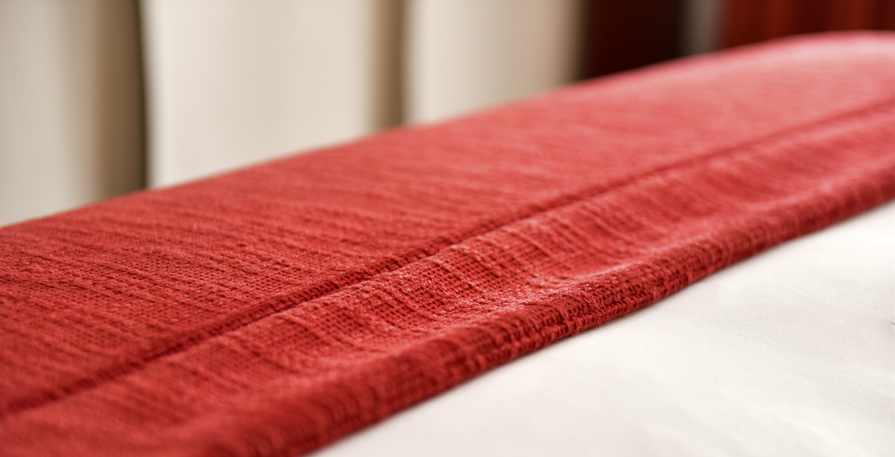 The Superior Double of The Pousada Marvão features a red bedspread folded at the foot of the bed