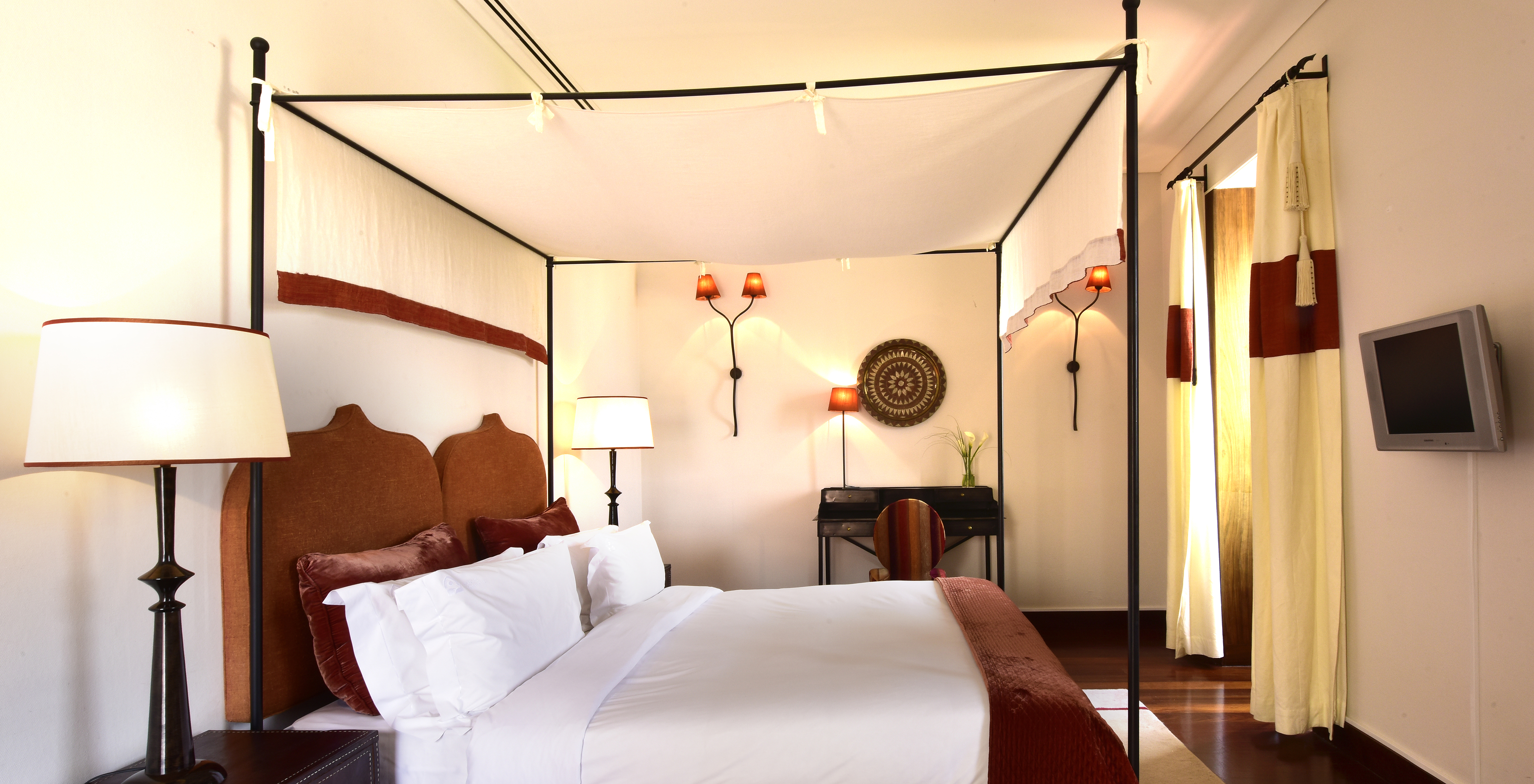 The Special Suite of The Pousada Convento Tavira has a double bed, two bedside tables, and a television in front of the bed