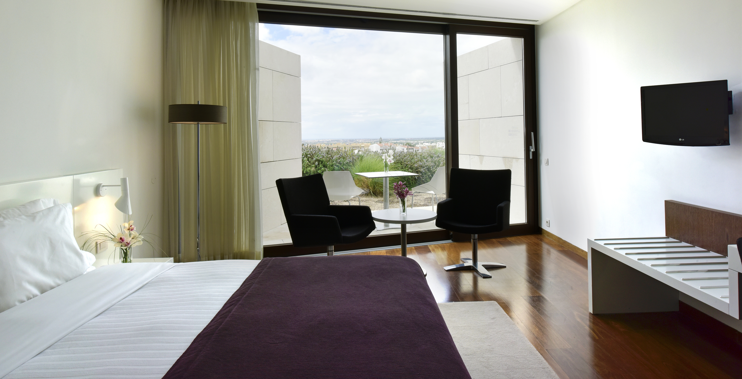 The Superior Premium View of The Pousada Palácio Estoi has a table with two chairs, a window, and a television