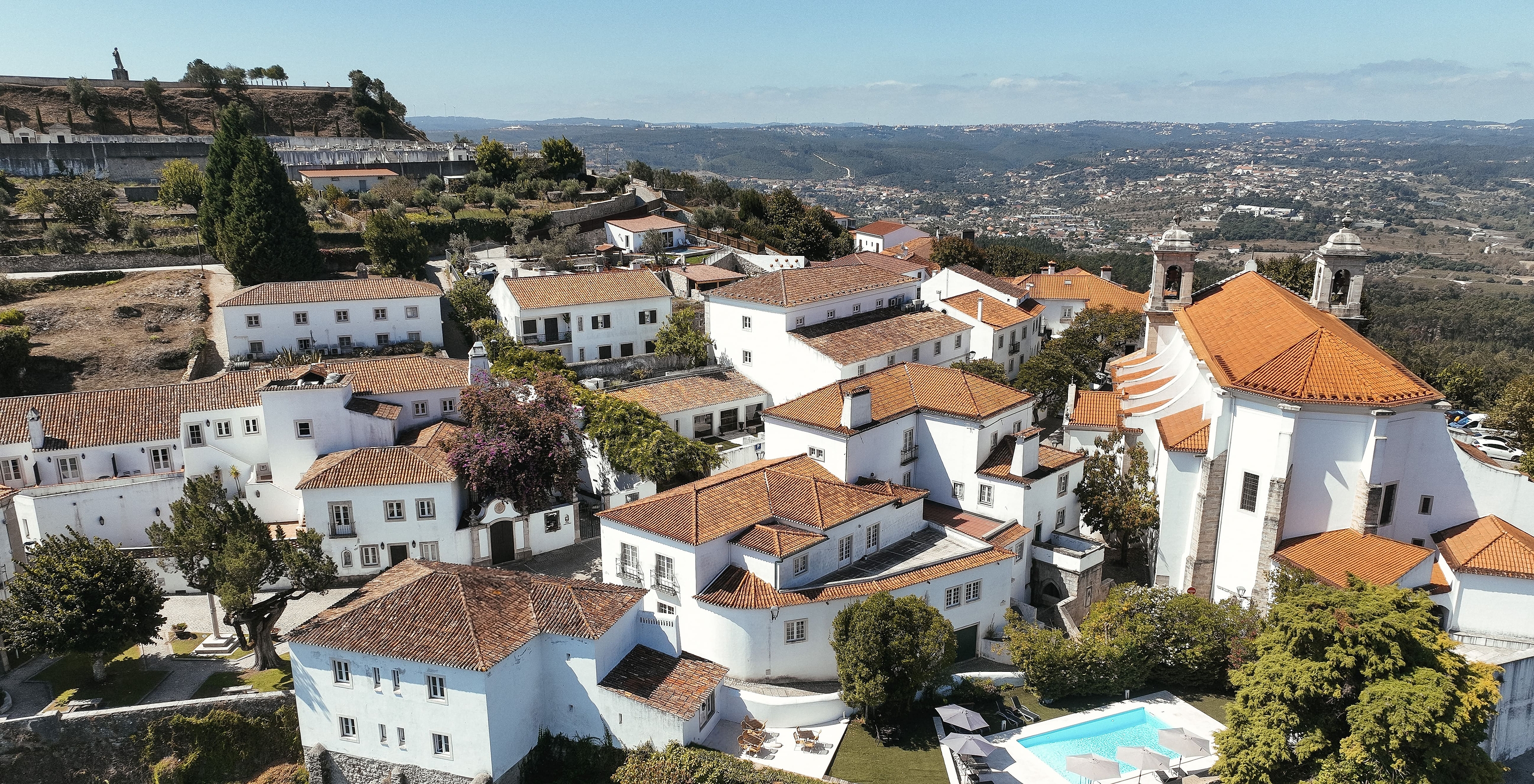 Aerial view of Ourém village and Pousada Ourém, near Fátima, with various houses and some trees among them