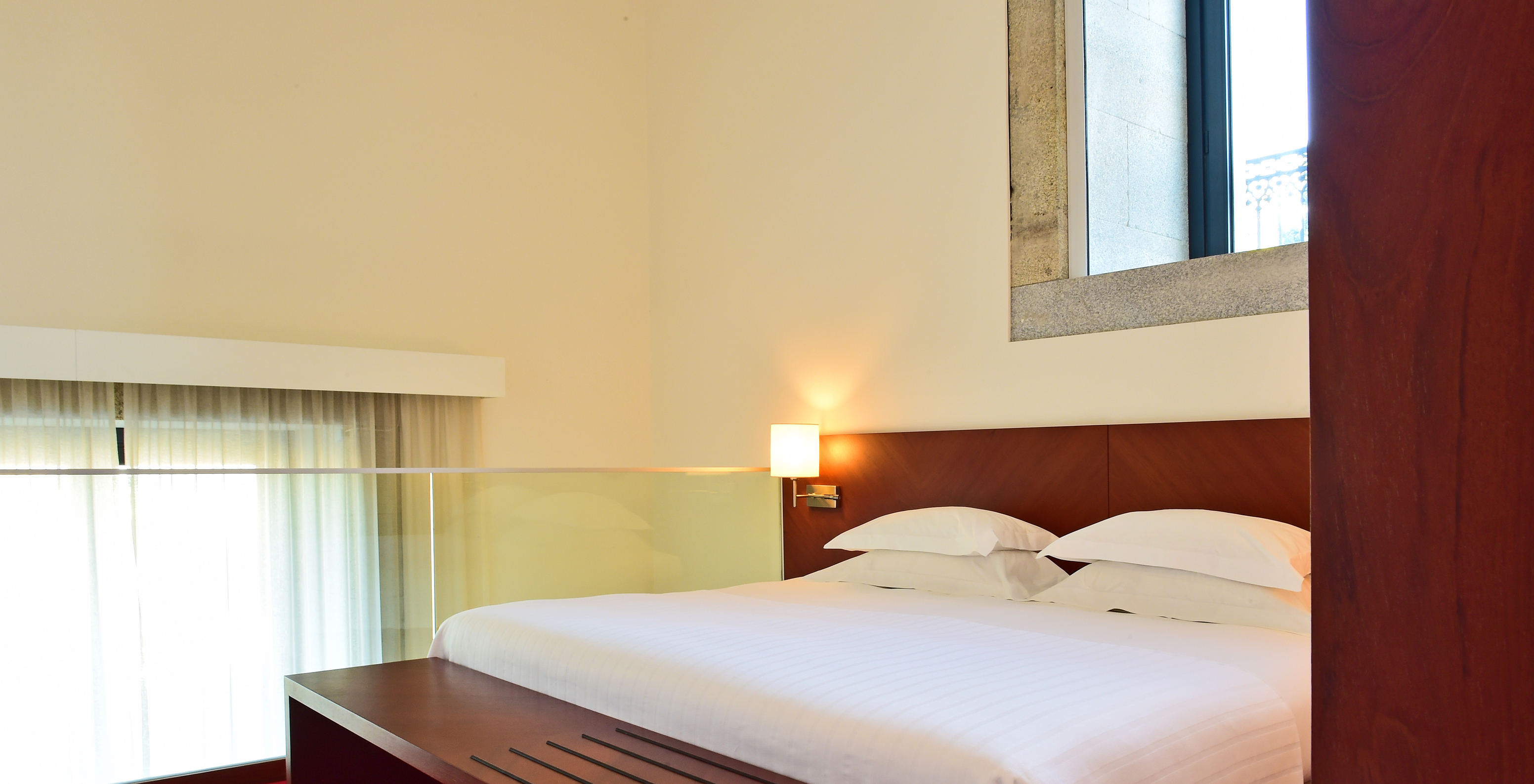 The Mezzanine Suite of the Pousada Viseu has a double bed in a mezzanine