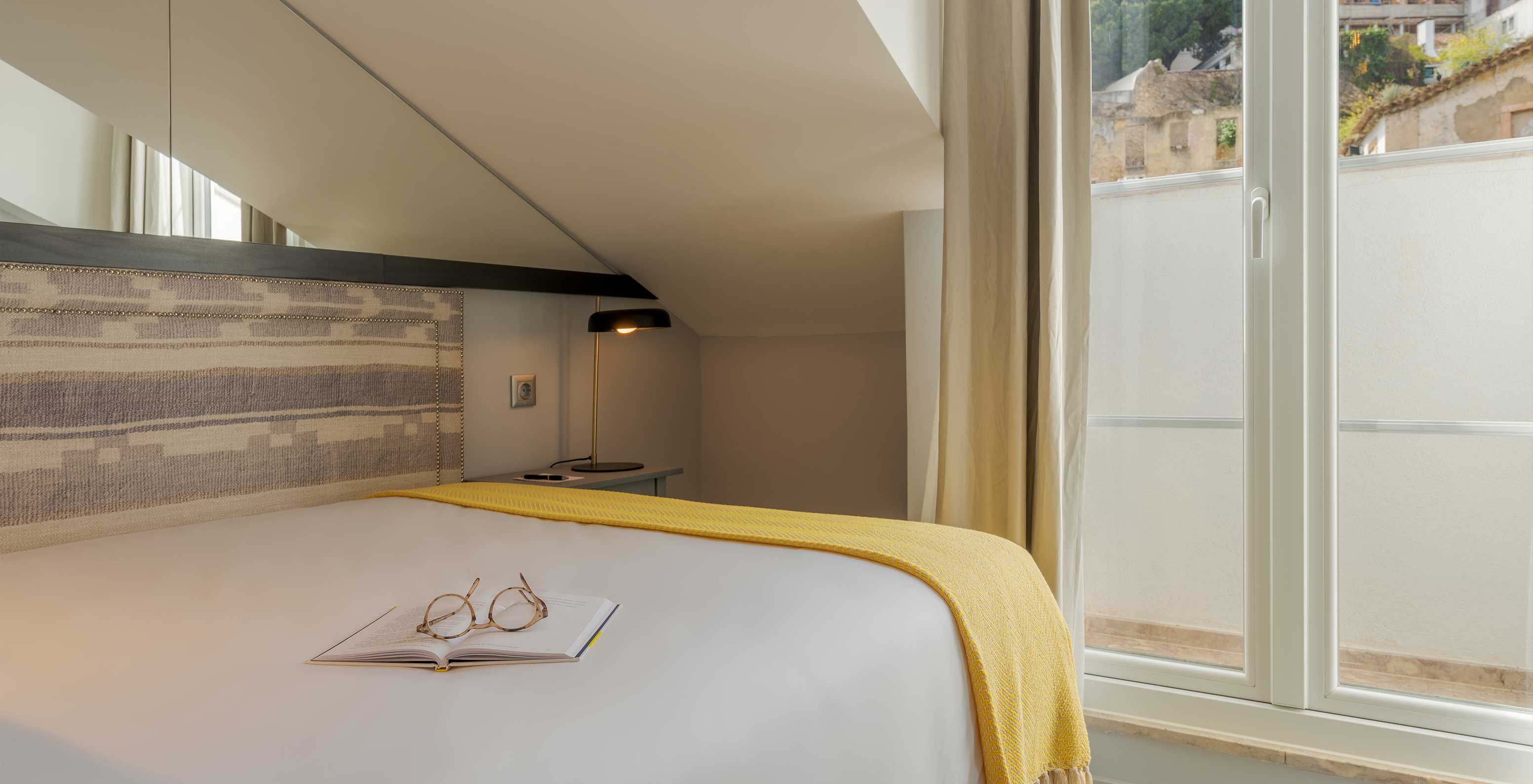 The Cozy Room at Pousada Alfama has a window at the back of the room with view of the historical part of the city