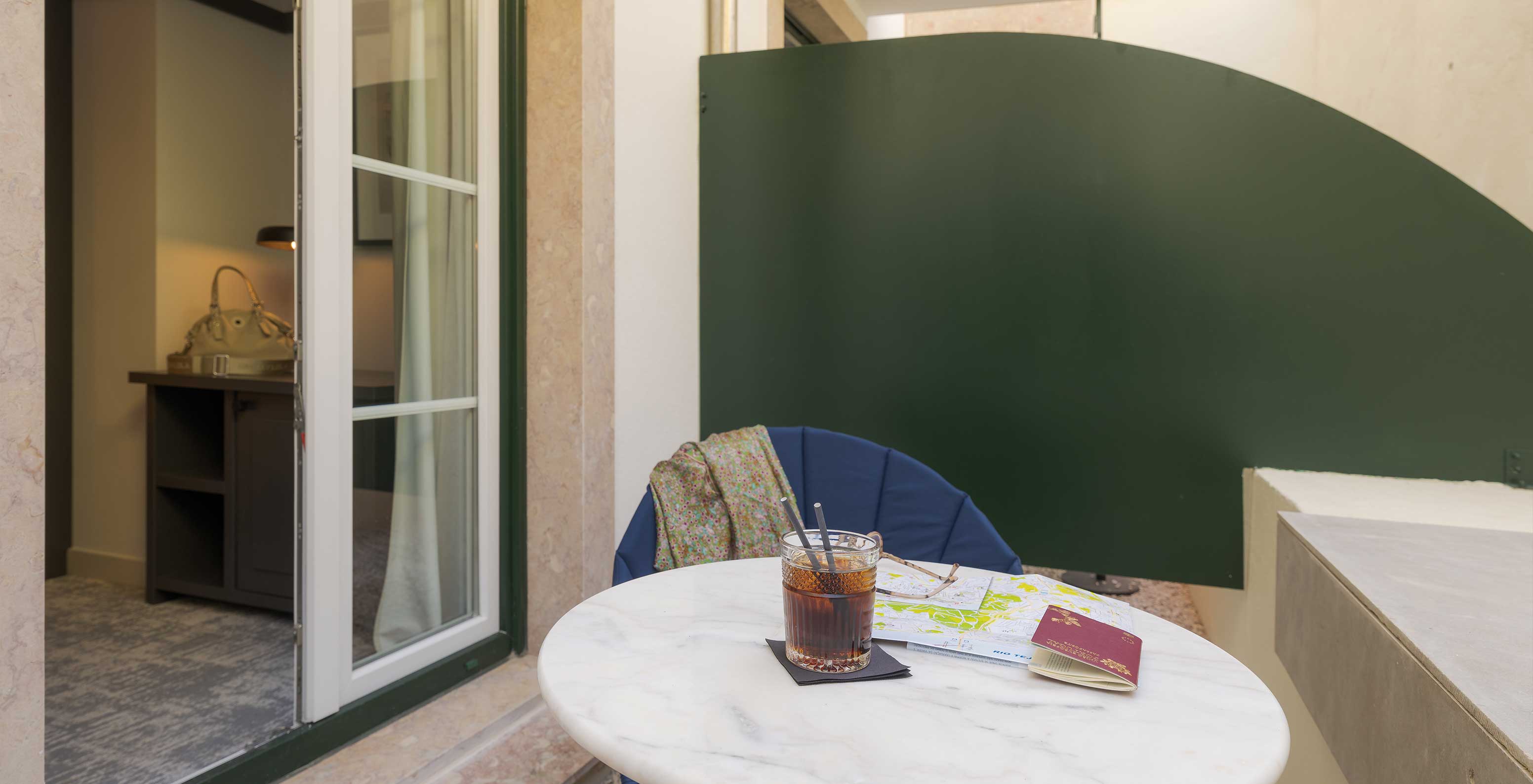 The Comfort Terrace at Pousada Alfama has a small balcony with table and chairs where you can relax and have a drink