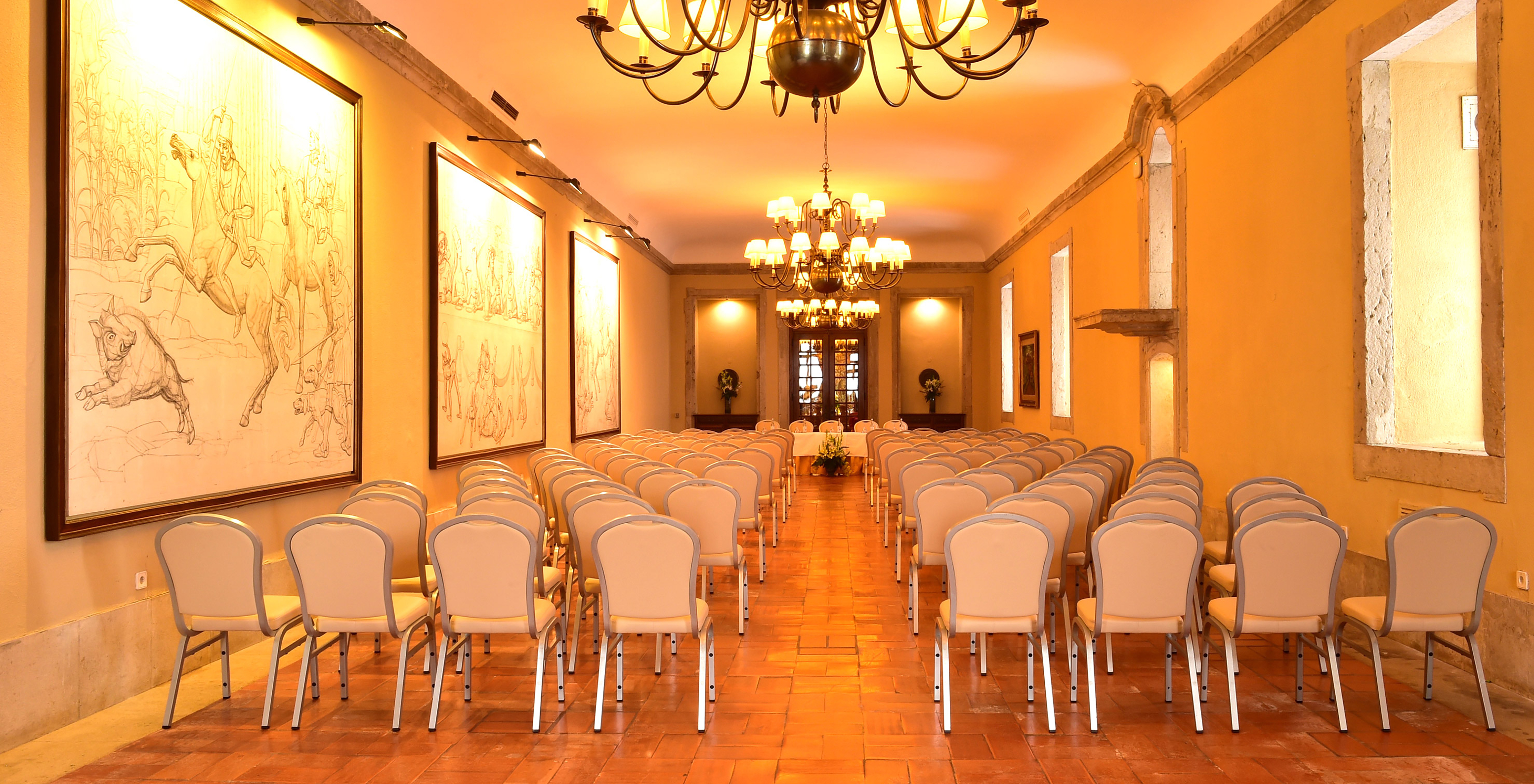 Conference room at Pousada Castelo Palmela, hotel in Palmela, with several chairs, paintings, and golden chandeliers