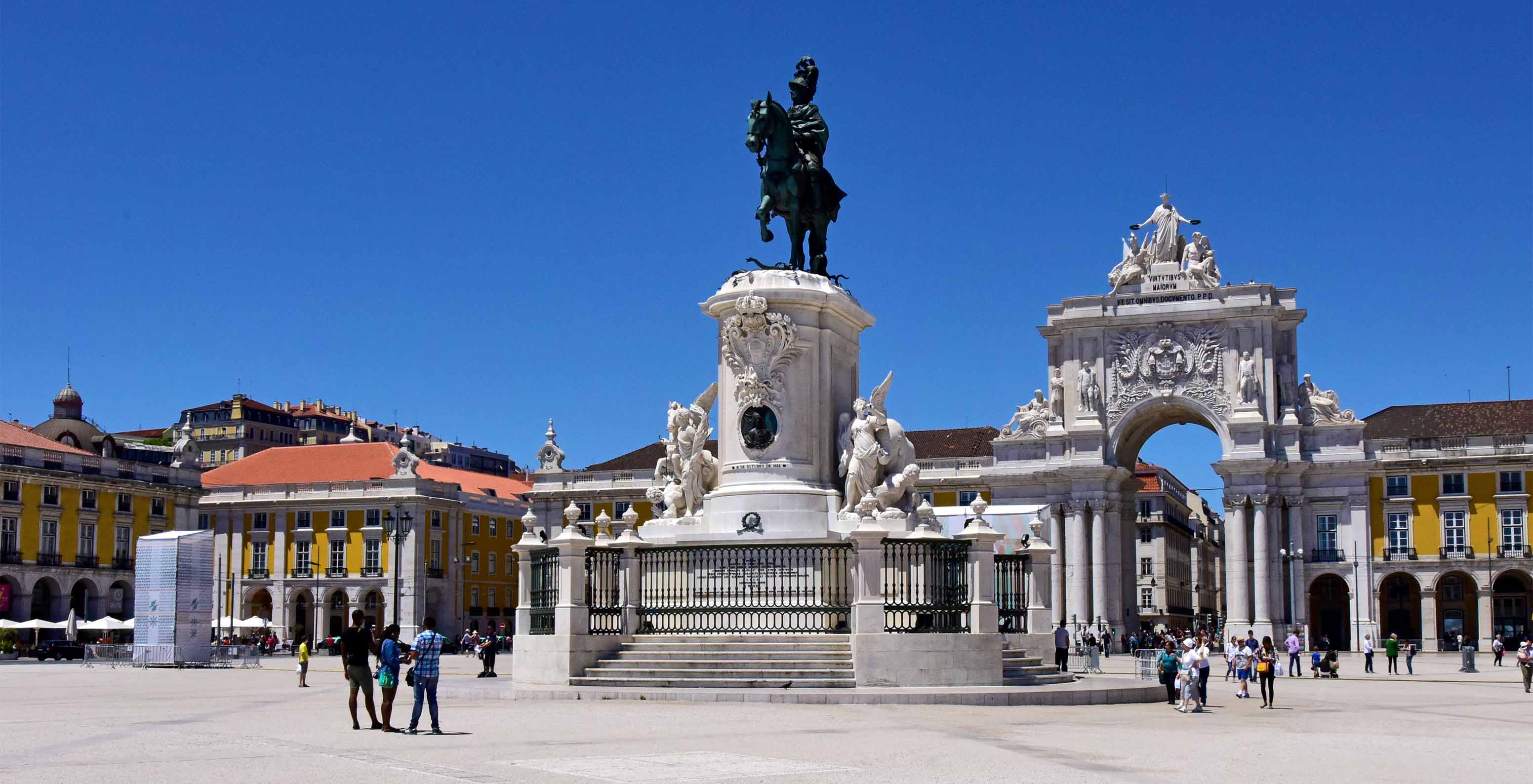 Statue of D. José I in the center of Praça do Comércio, with Rua Augusta Arch and Pousada Lisboa in the background