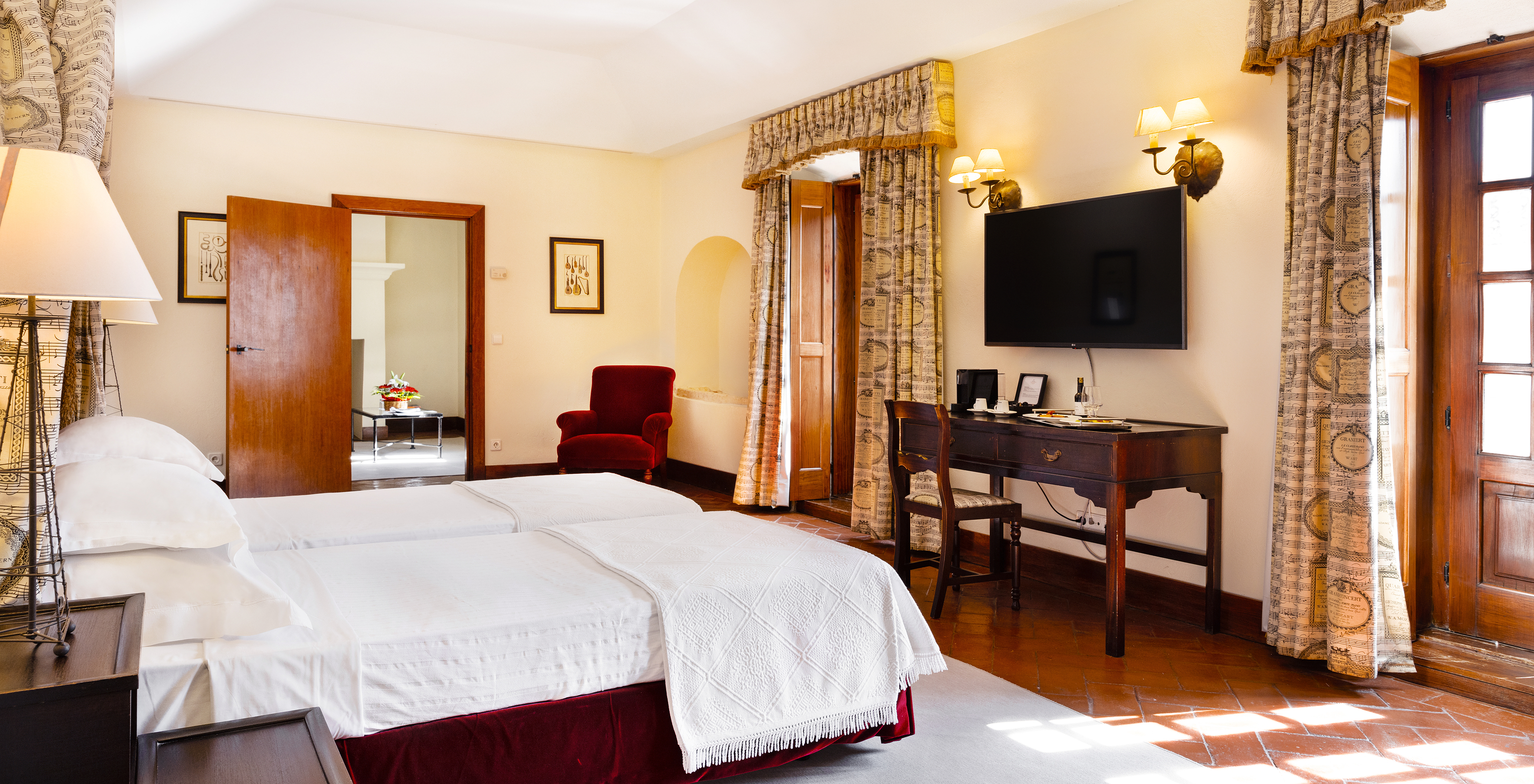 The Master Suite of The Pousada Convento Vila Viçosa has two joined beds with a television