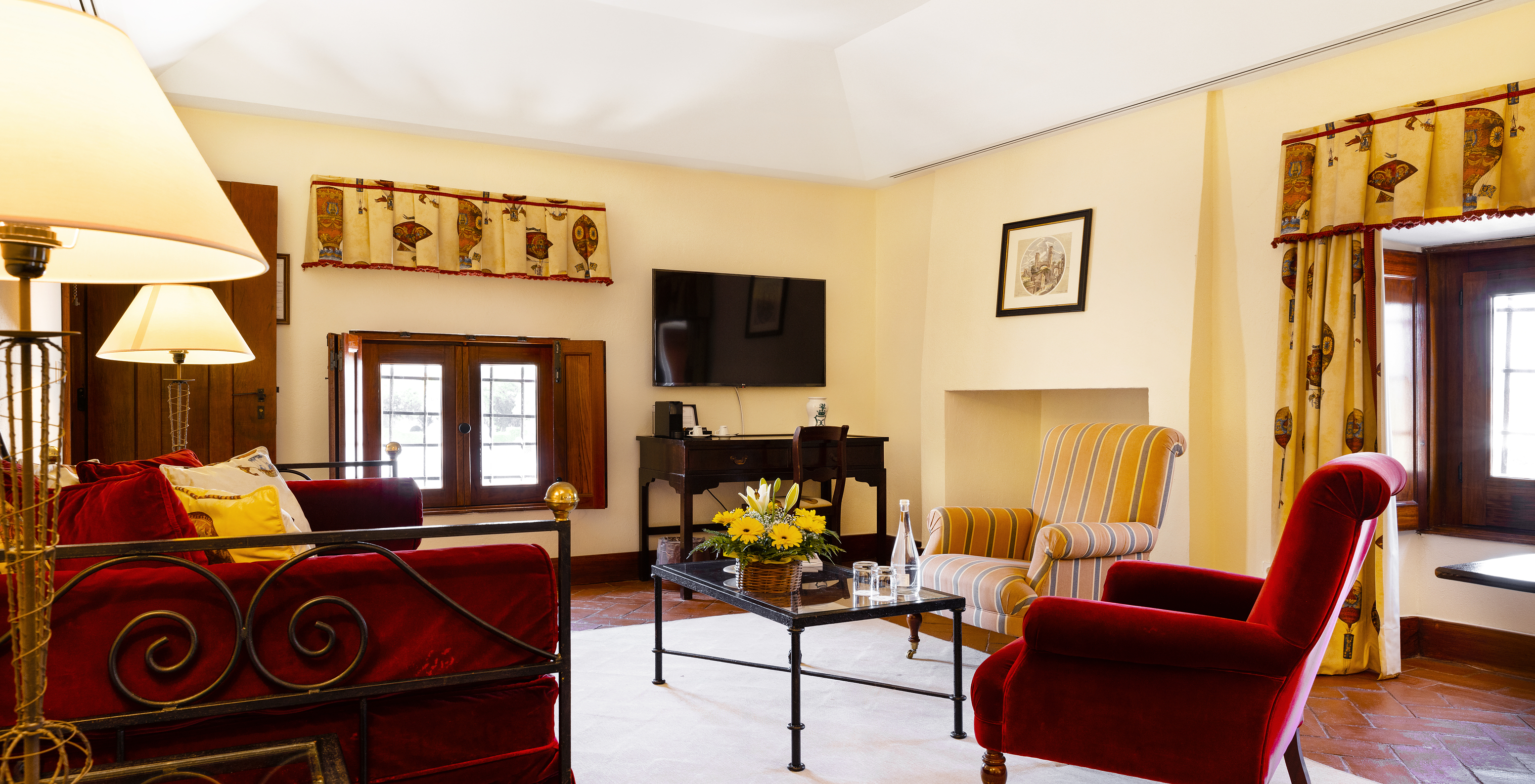 The Suite of The Pousada Convento Vila Viçosa has a seating area with a sofa, two armchairs, and a television