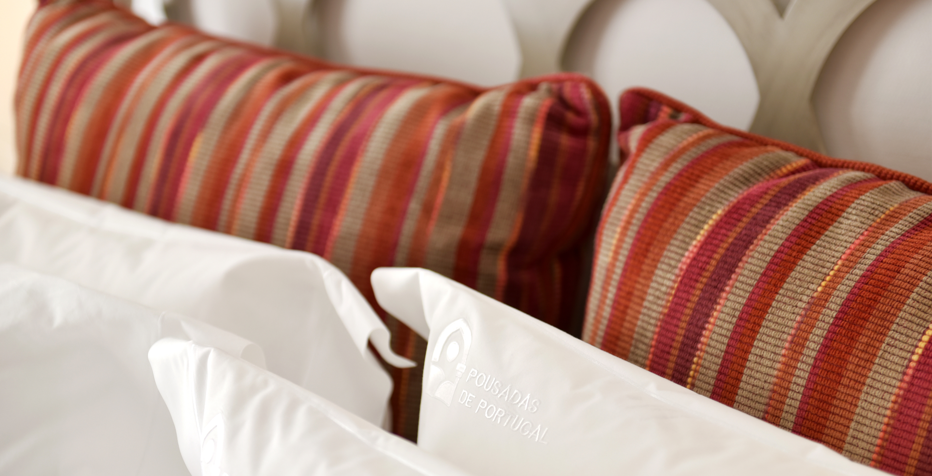 The Double Room of The Pousada Marvão features customized white cushions and striped cushions