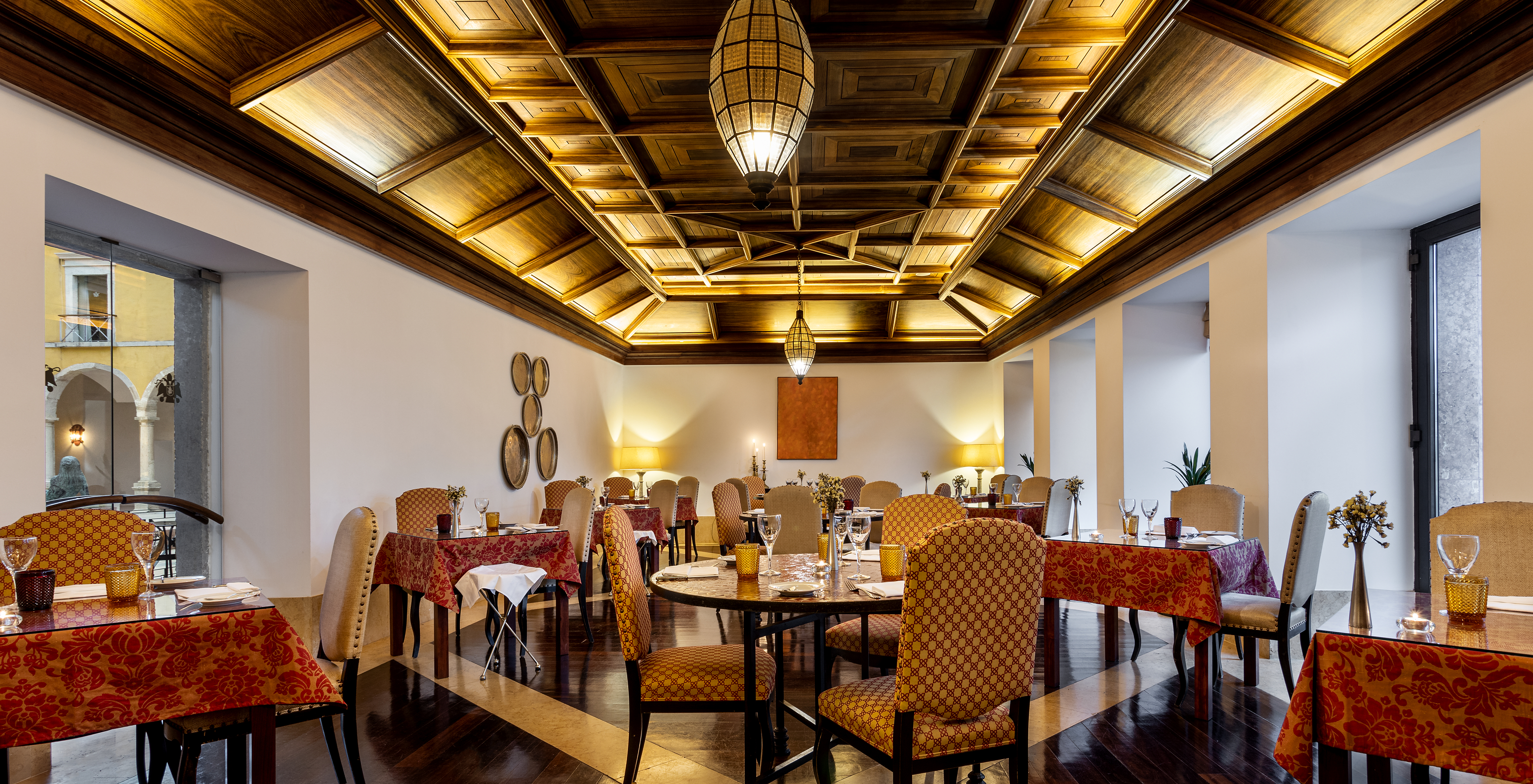 The Mouraria restaurant at the Hotel in Historic Tavira has several tables and a wooden decorative ceiling