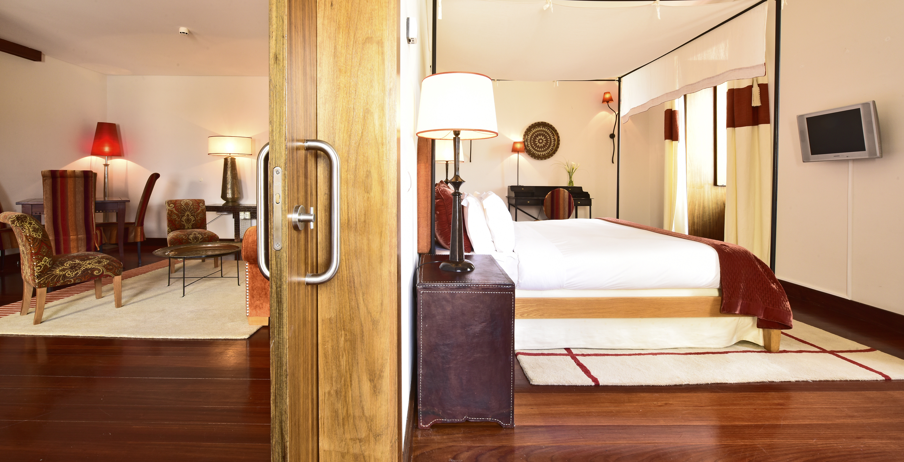 The Special Suite of The Pousada Convento Tavira has a sliding door that separates the bedroom and the living room