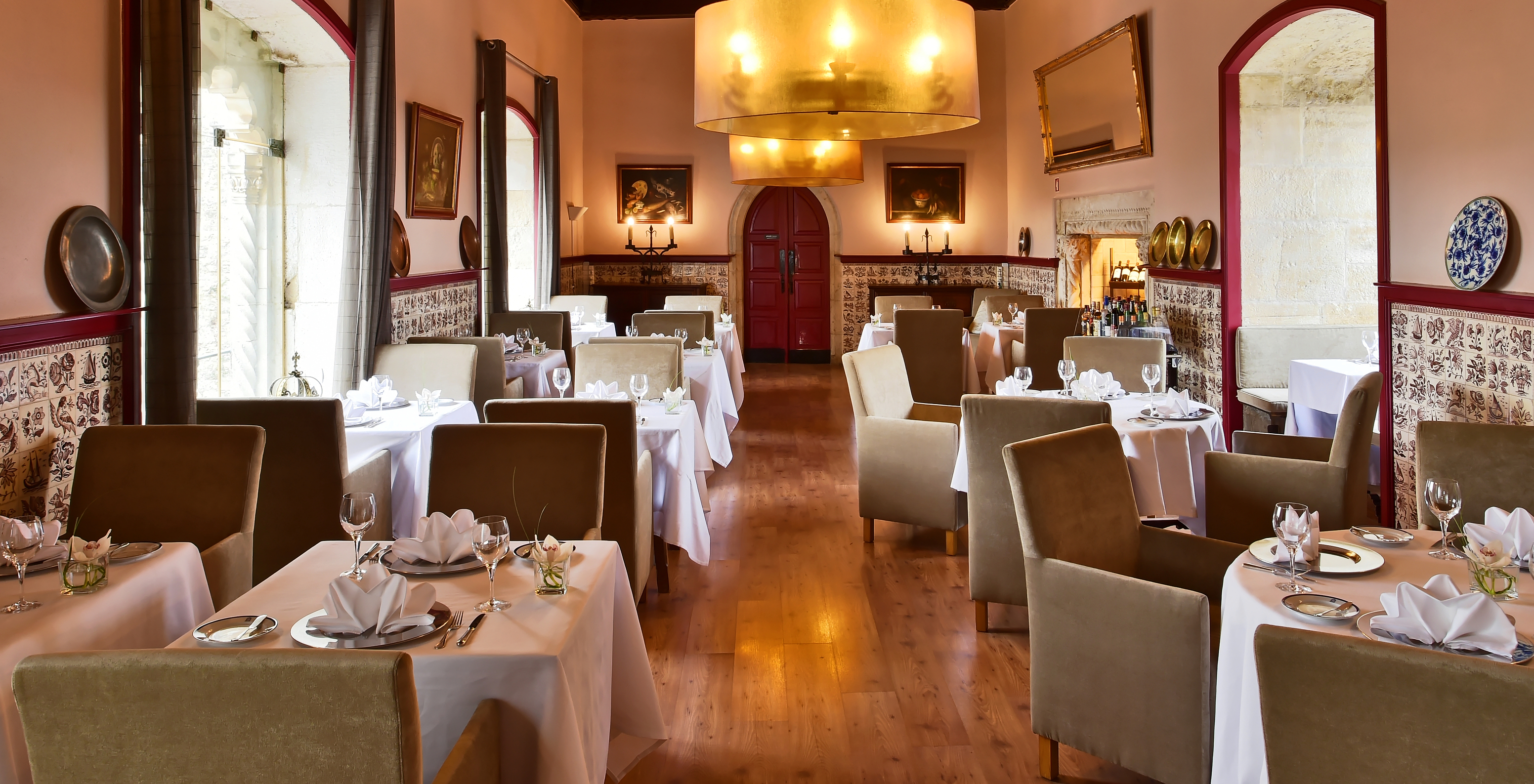 The Pousada Castelo Óbidos restaurant at the Hotel in the Medieval Village of Óbidos has rustic decor and tiled walls