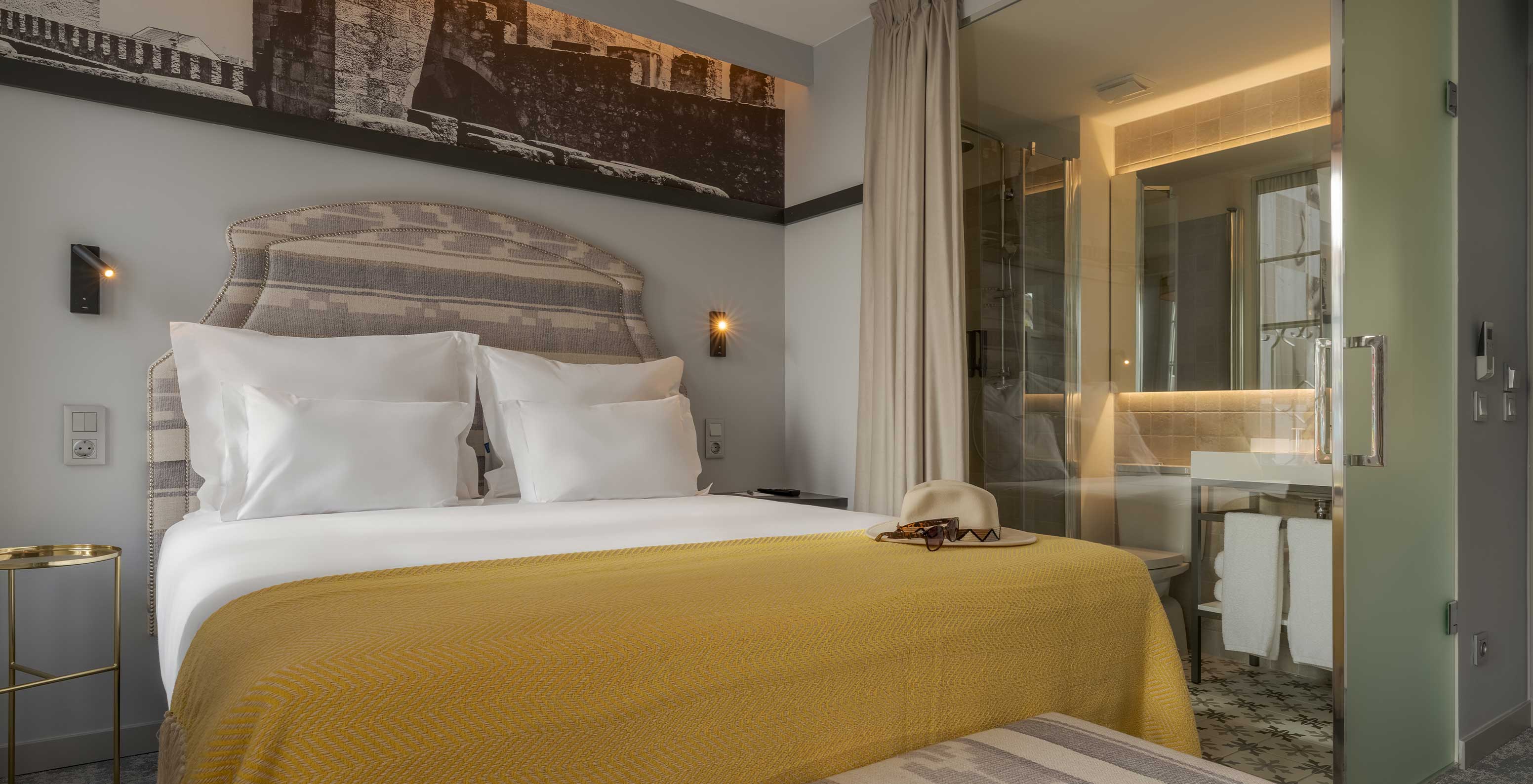 The Superior River View room at Pousada Alfama has a double bed in a spacious room with glass bathroom