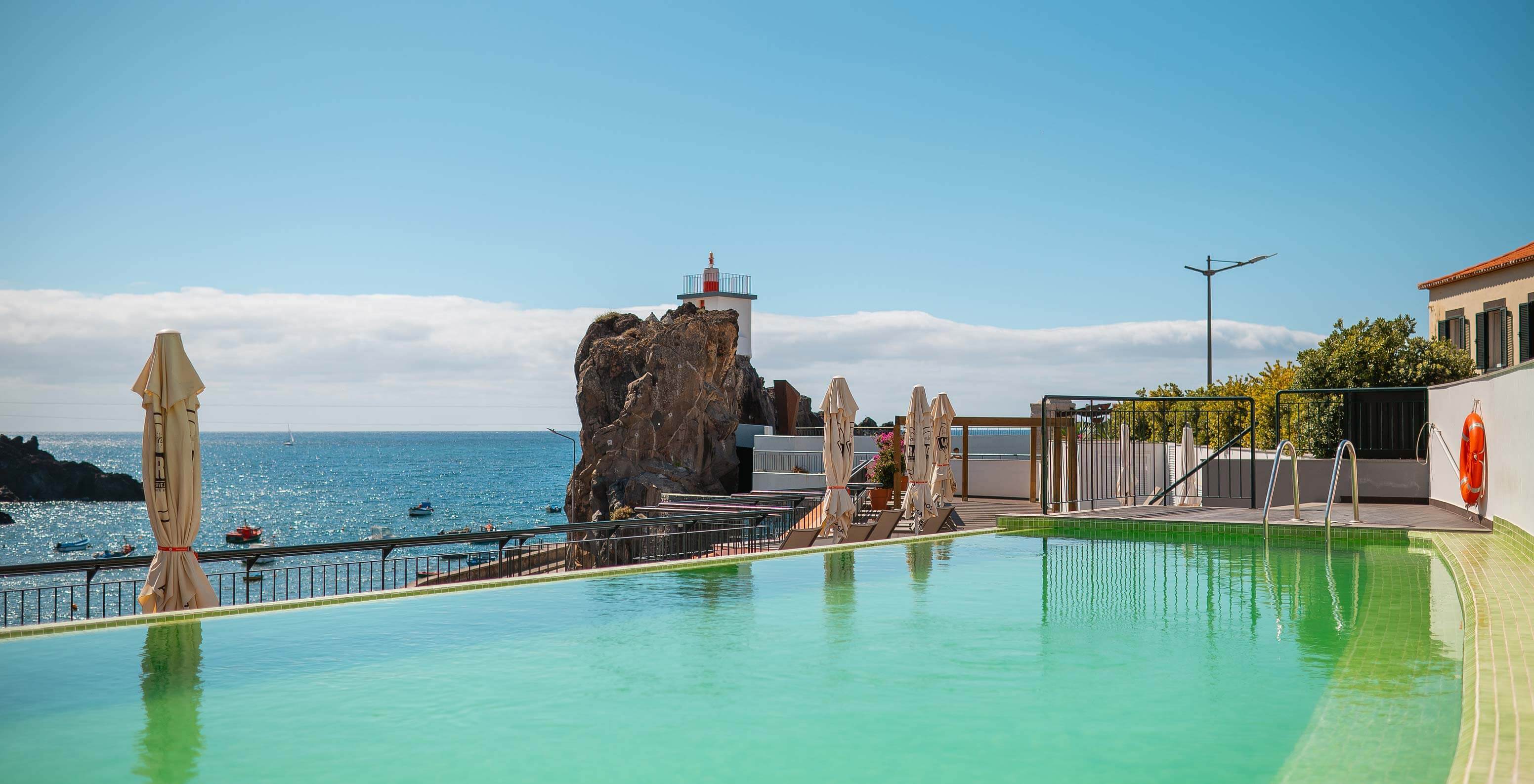 Outdoor pool at Pestana Churchill Bay with panoramic view of Câmara de Lobos Bay in Funchal