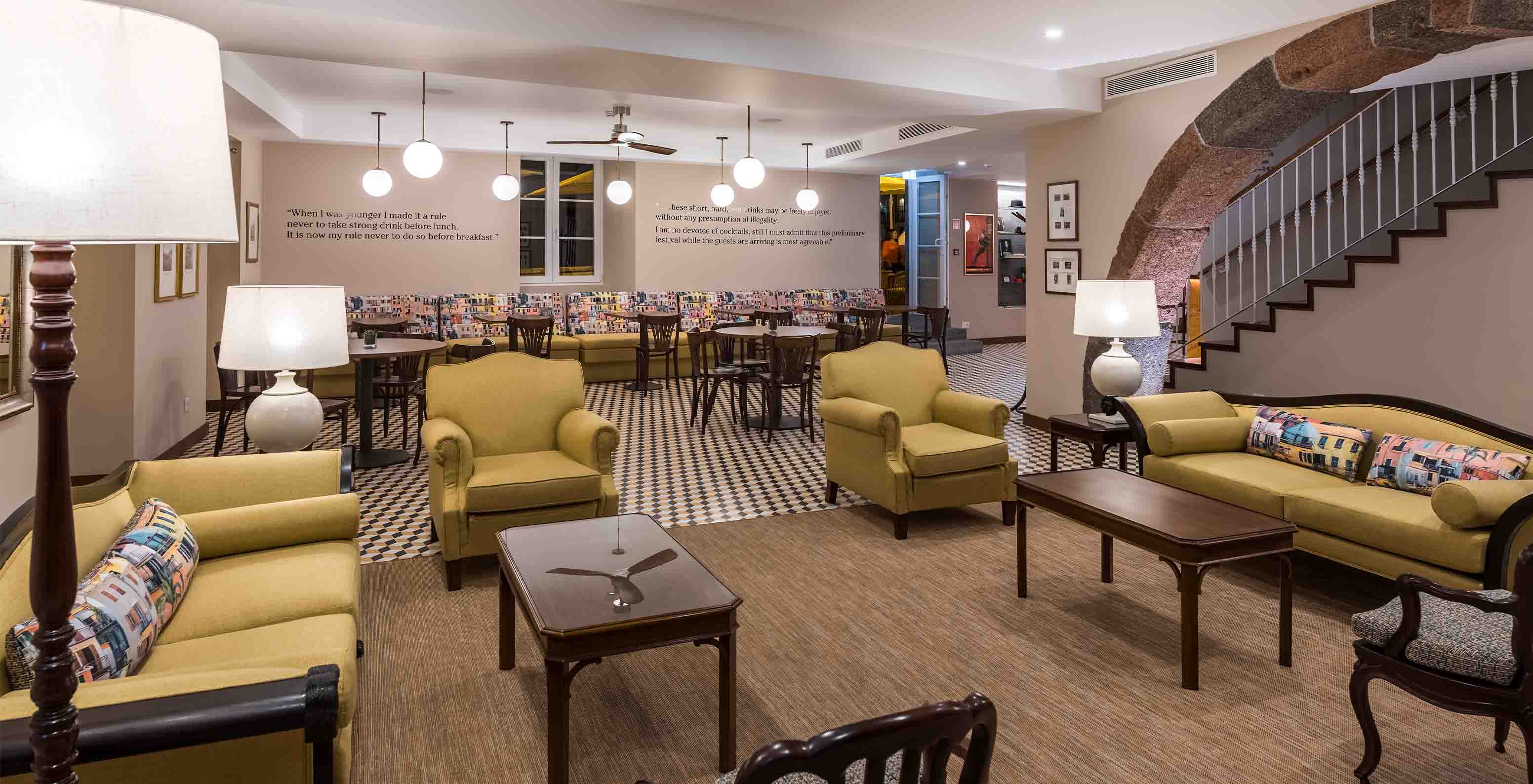 Hotel in Câmara de Lobos Bay, near Funchal, has a sitting area with yellow sofas and armchairs