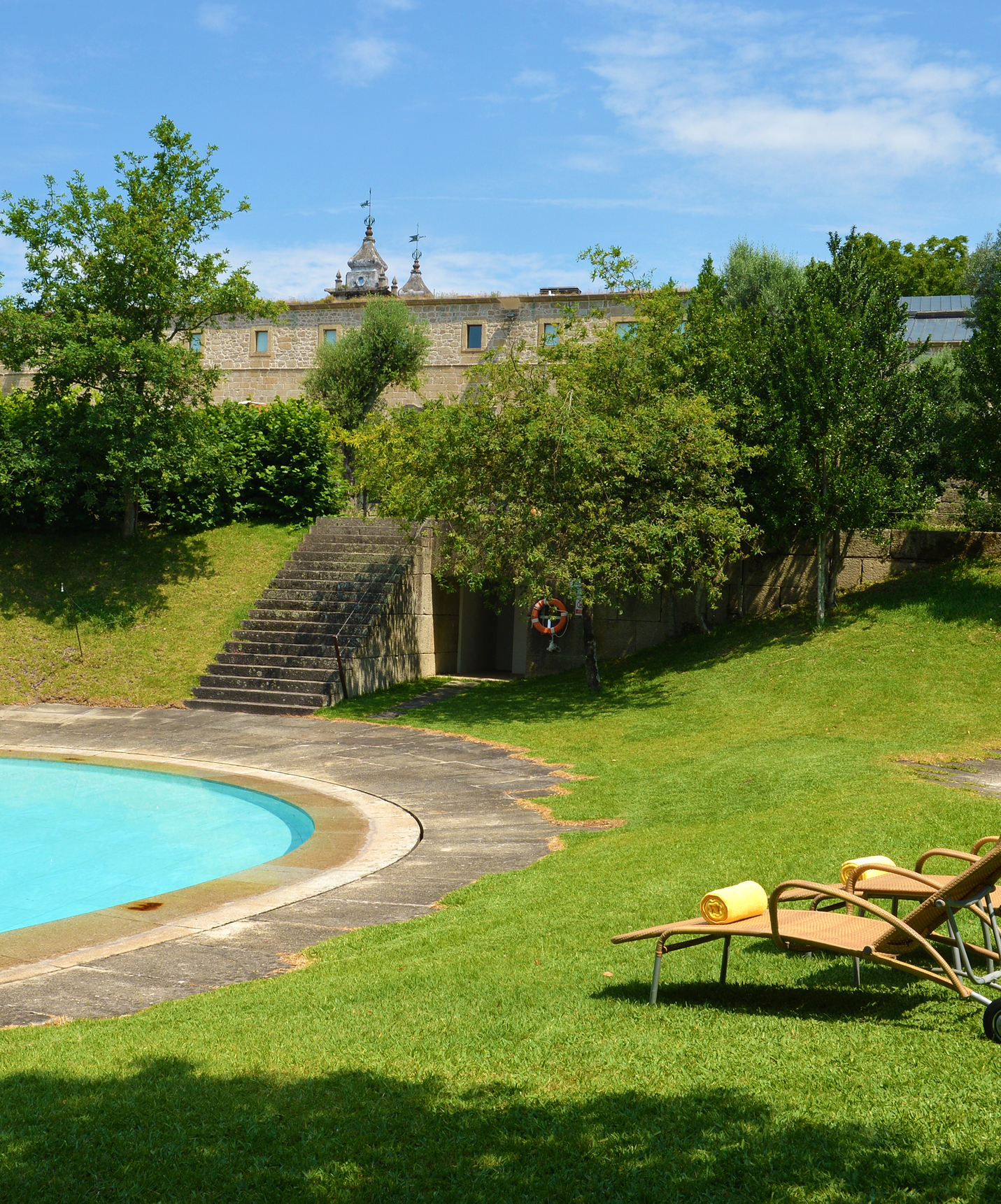 Pousada Mosteiro Amares, a historic hotel in Amares, has an outdoor pool with loungers and grass around