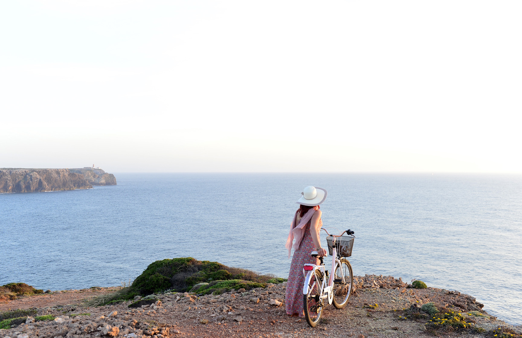 Enjoy bike rides at Pousadas de Portugal Woman cycling on a dirt road through the dunes, with a bicycle from Pousadas de Portugal