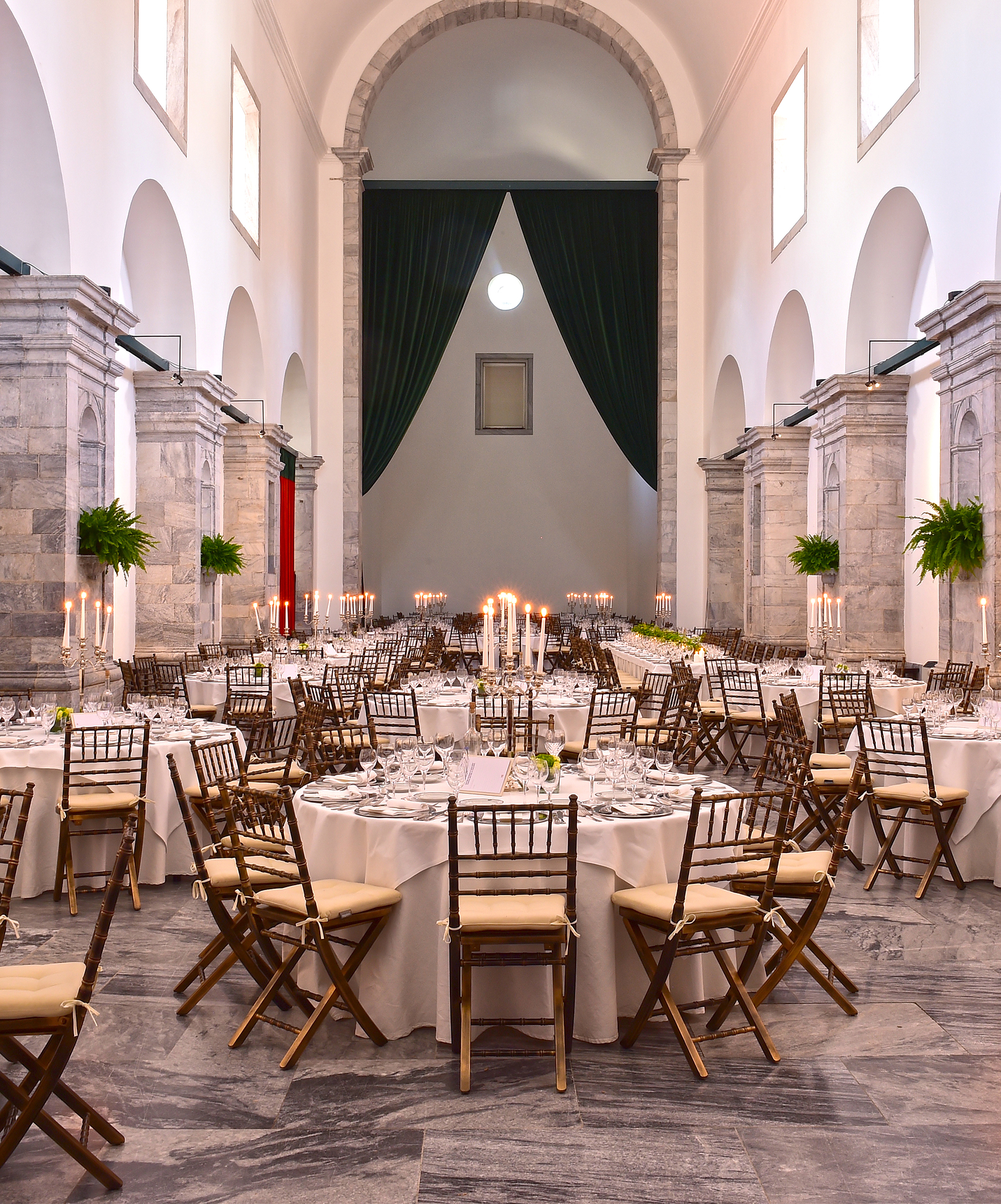 Ala de Pousada Convento Beja preparada para un evento con mesas redondas, sillas alrededor