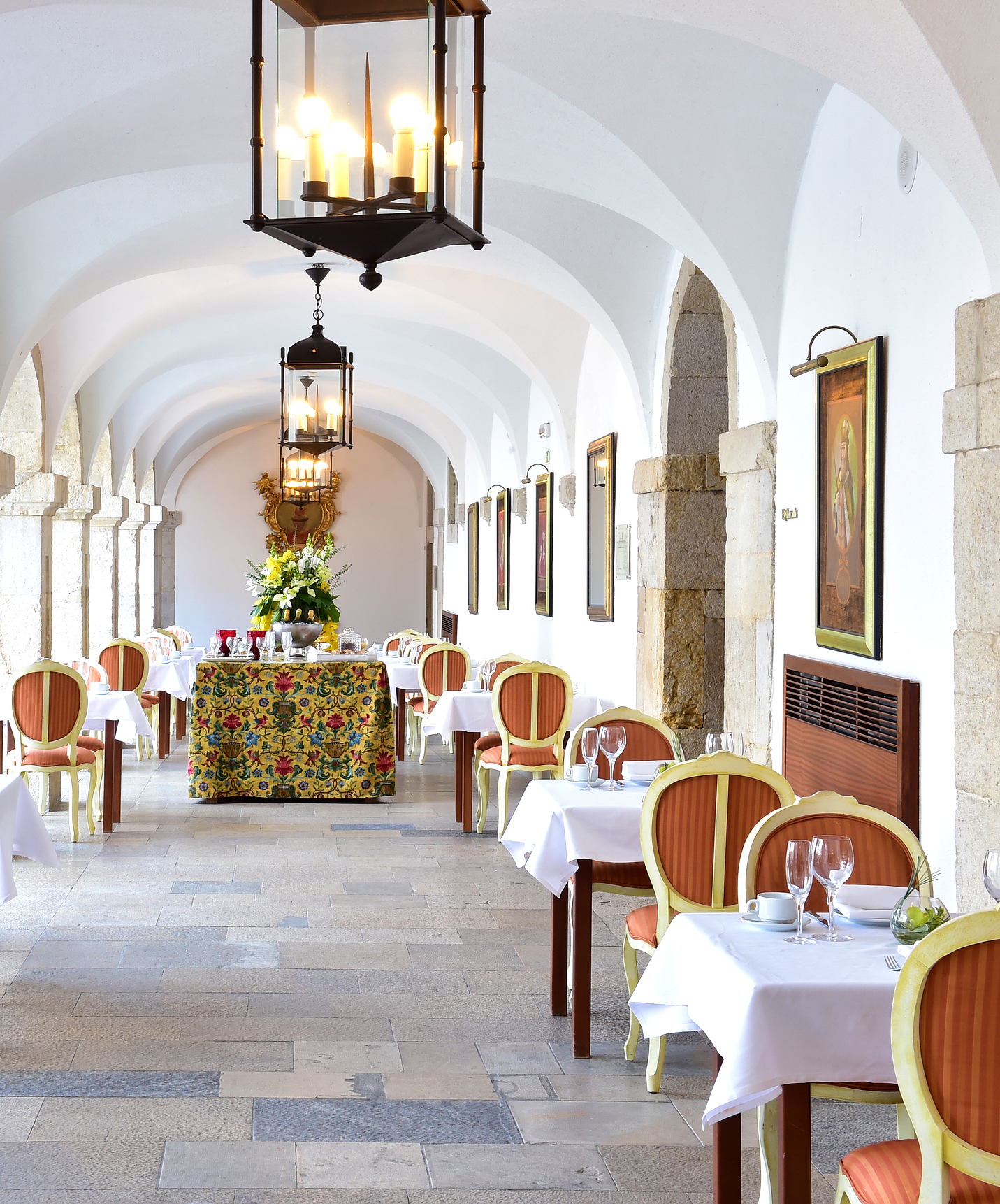 Restaurante con techos altos y arcos y paredes de piedra en Pousada Castelo Palmela