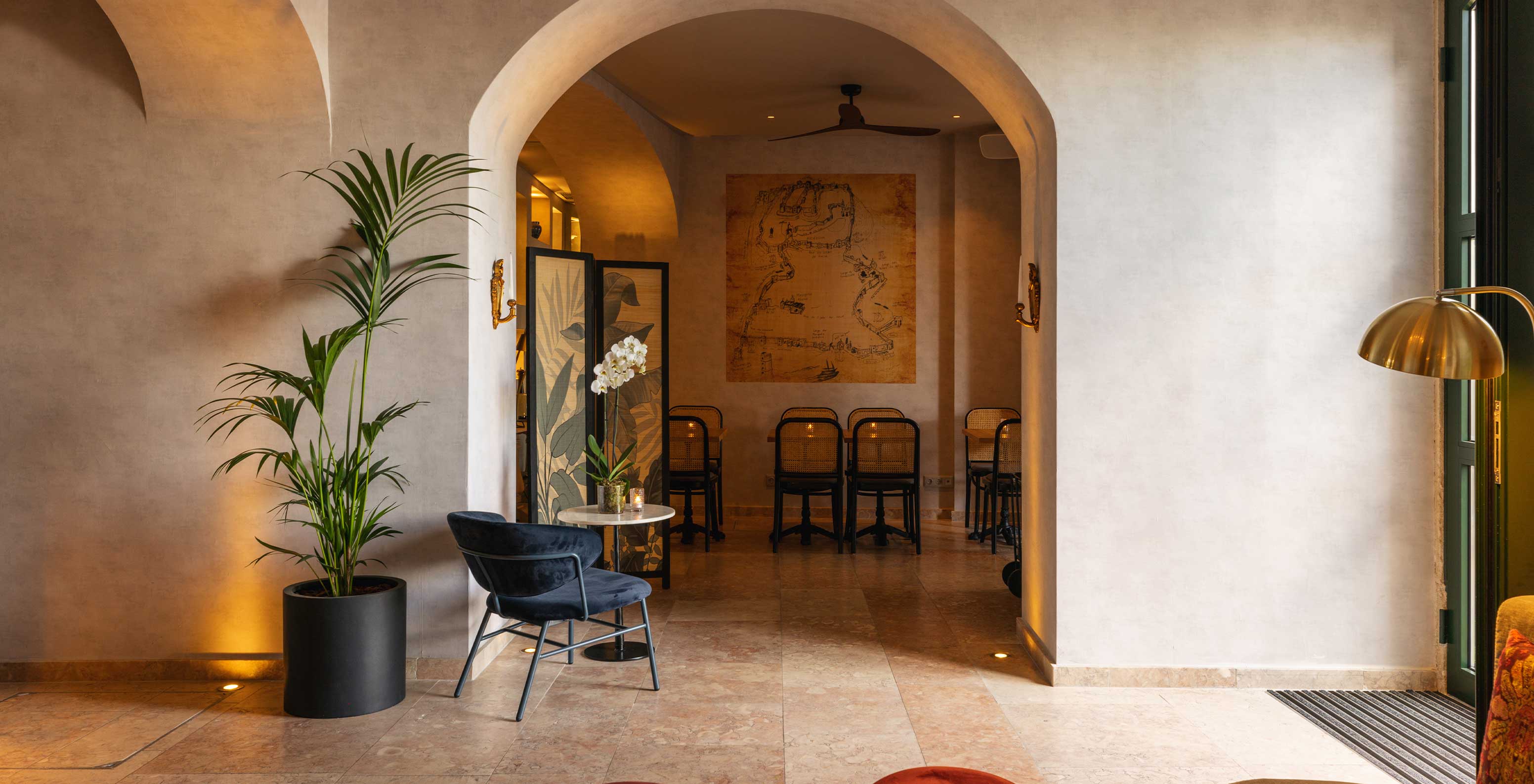 Hall accueillant de la Pousada de Alfama avec canapés, fauteuils, un grand miroir et un chandelier, où l'on peut se reposer